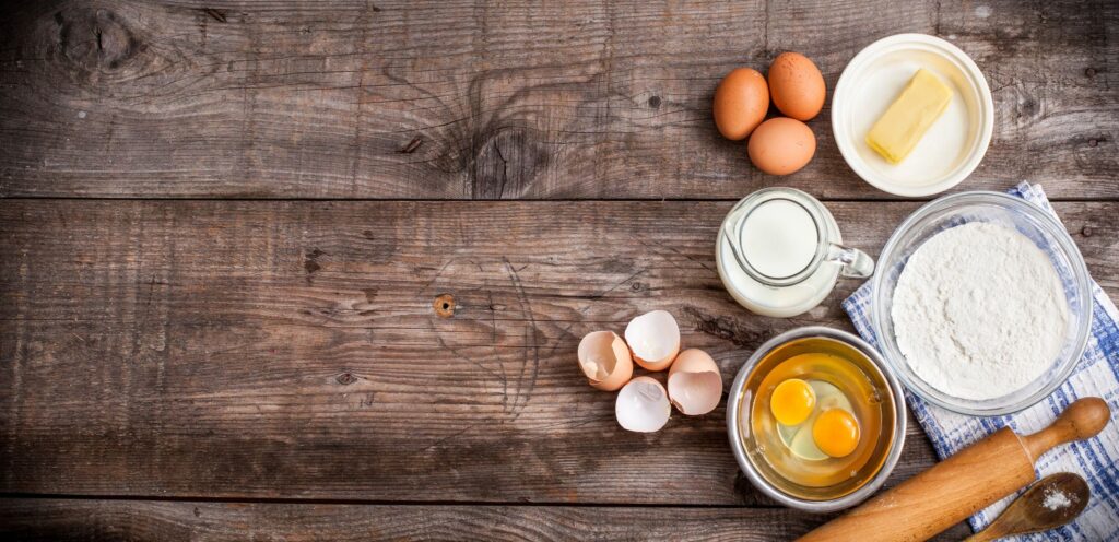 rustic table with eggs milk being prepared for meal